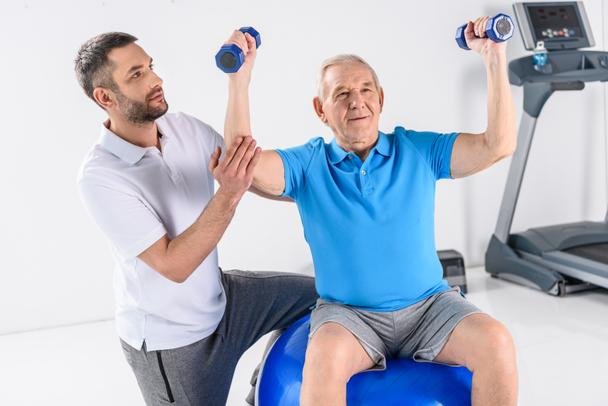 Physical therapist assisting a patient during exercise